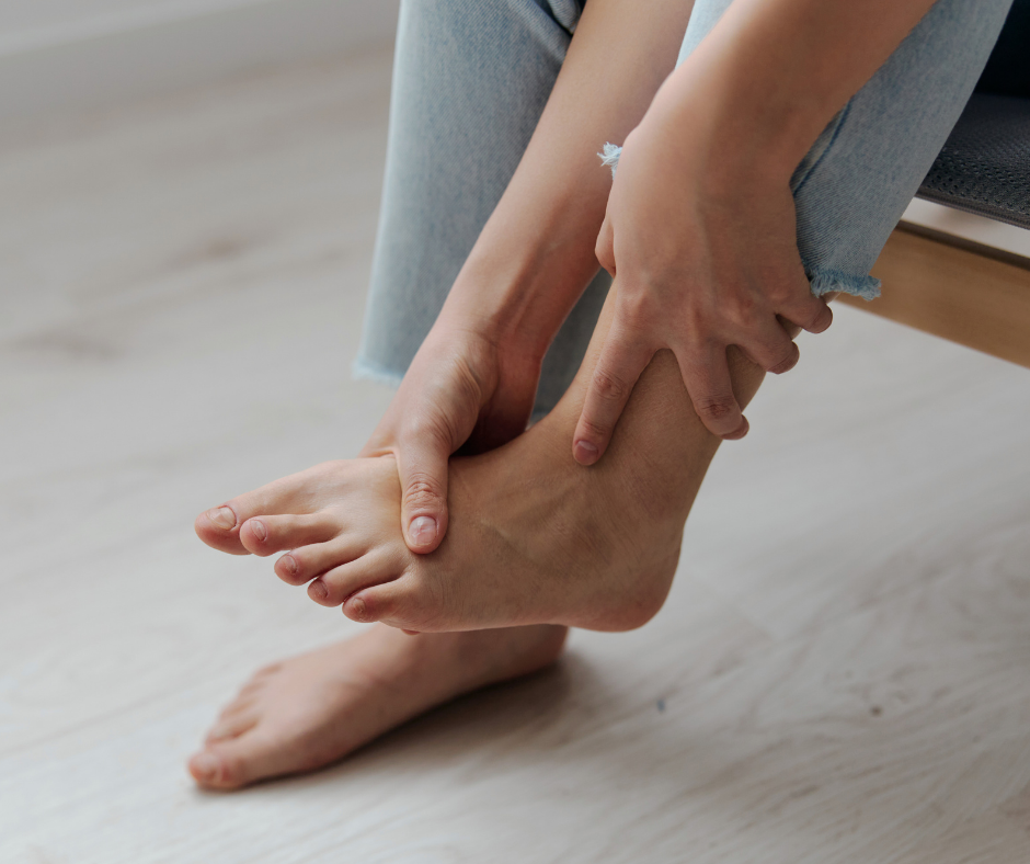 woman holding foot